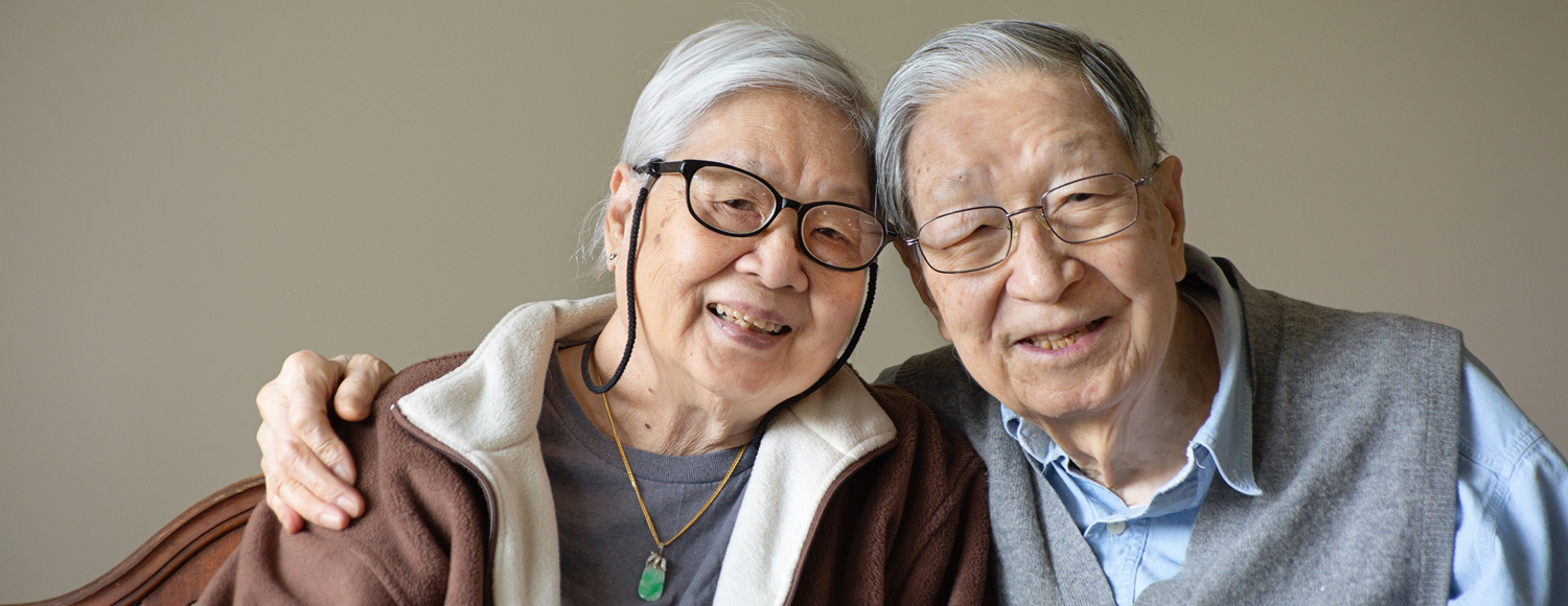 Asian couple with glasses looking at the camera